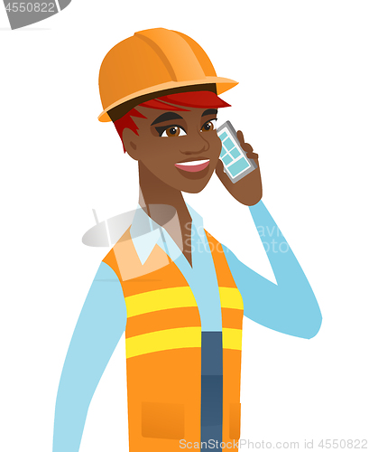 Image of Young african builder talking on a mobile phone.