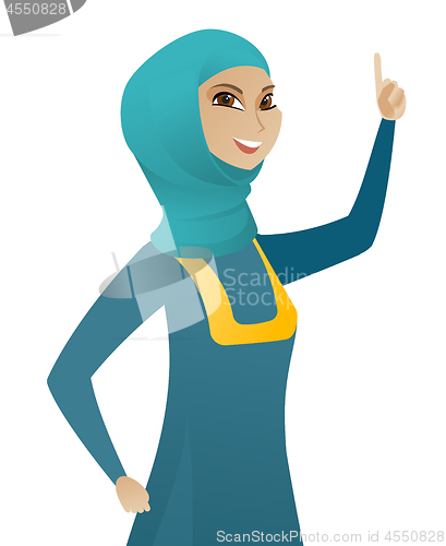 Image of Young muslim business woman pointing her finger up