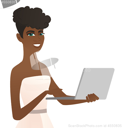 Image of Young african-american bride using a laptop.