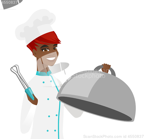 Image of African chef cooking chicken on barbecue grill.