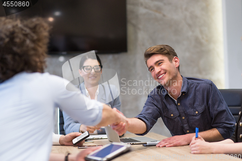 Image of cloasing the deal in modern office interior