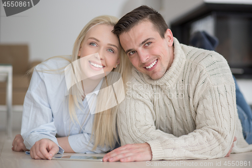 Image of Young Couple using digital tablet on cold winter day