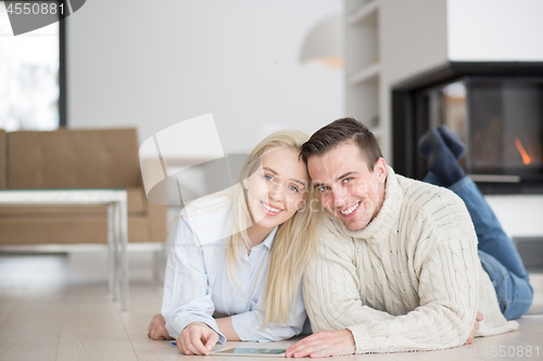 Image of Young Couple using digital tablet on cold winter day