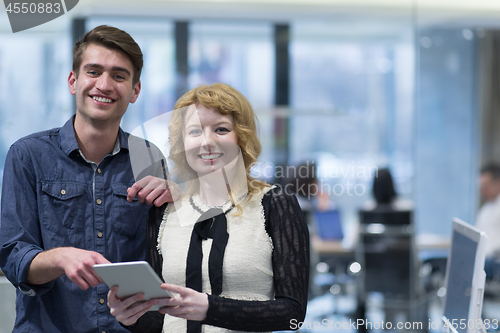 Image of Business People Working With Tablet in startup office