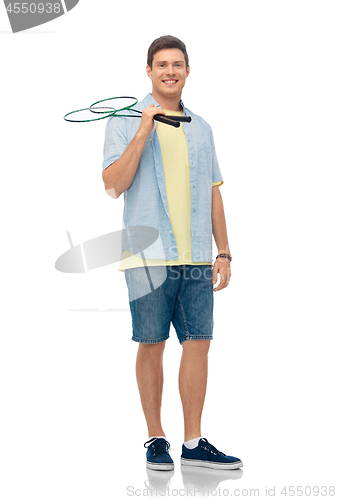 Image of smiling young man with badminton rackets