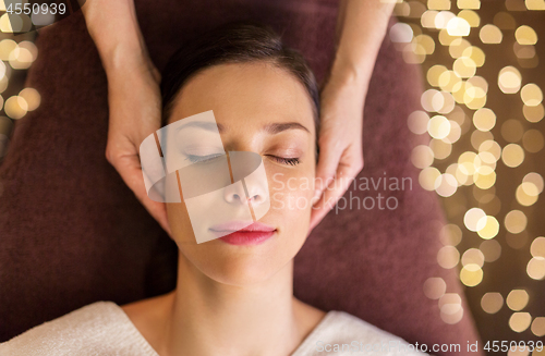 Image of woman having face and head massage at spa