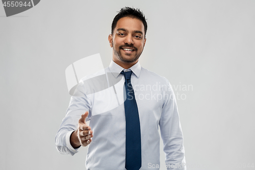 Image of indian businessman stretching hand for handshake