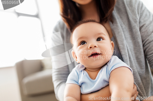 Image of close up of asian baby boy with mother