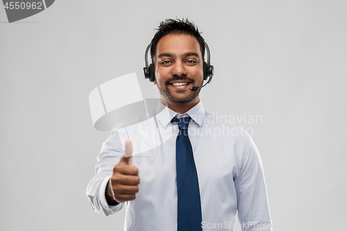 Image of businessman or helpline operator showing thumbs up