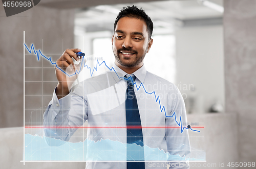 Image of businessman with marker drawing chart at office