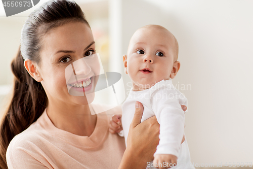 Image of happy mother with little baby boy at home