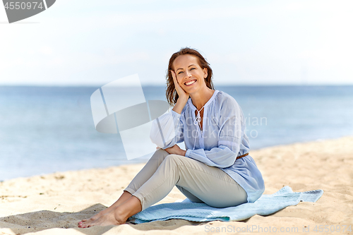 Image of happy smiling woman on summer beach