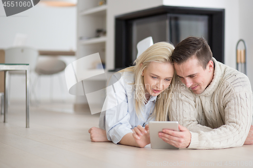 Image of Young Couple using digital tablet on cold winter day