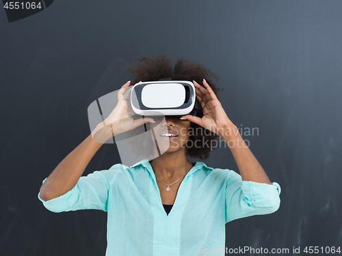 Image of black girl using VR headset isolated on gray background