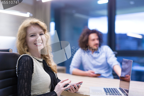 Image of Elegant Woman Using Mobile Phone in startup office building