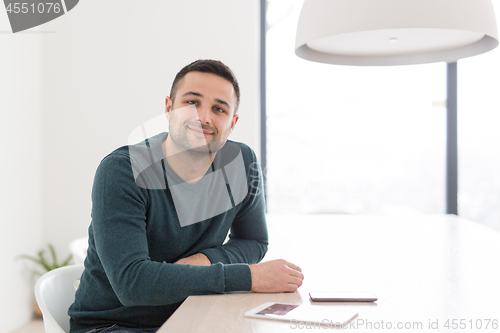 Image of Young casual businessman using smartphone