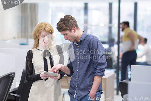 Image of Business People Working With Tablet in startup office