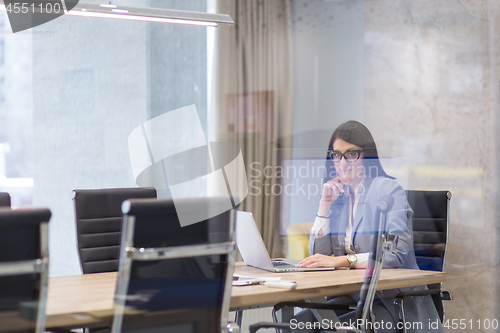 Image of businesswoman using a laptop in startup office