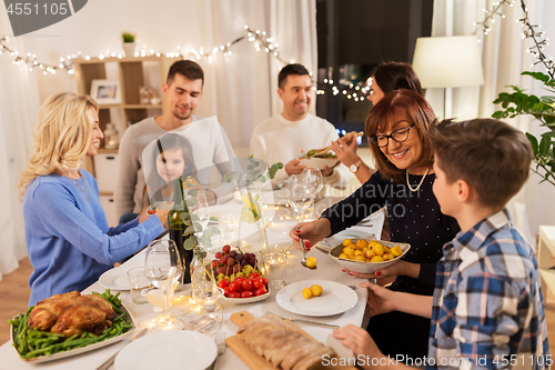 Image of happy family having dinner party at home