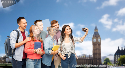 Image of students taking selfie by smartphone over london