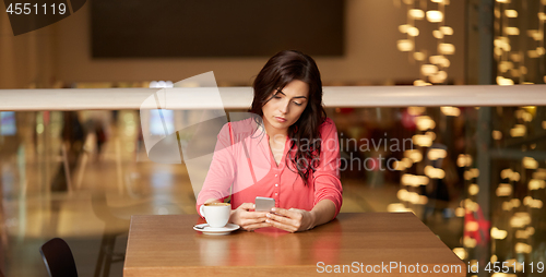 Image of woman with coffee and smartphone at restaurant