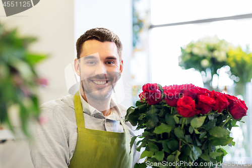 Image of florist or seller with red roses at flower shop