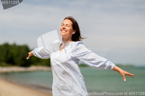 Image of happy smiling woman on summer beach