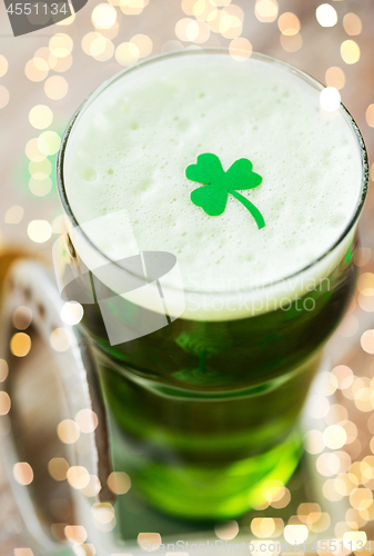 Image of close up of glass of green beer with shamrock