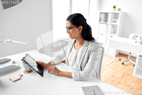 Image of businesswoman with tablet computer at office