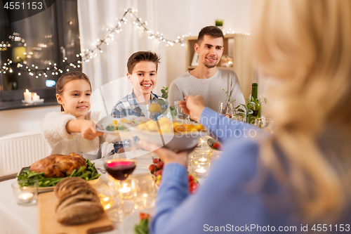 Image of happy family having dinner party at home