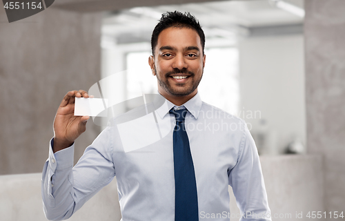 Image of indian businessman with business card over office