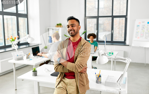 Image of smiling indian man with smart watch at office