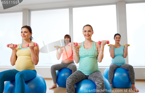 Image of pregnant women training with exercise balls in gym