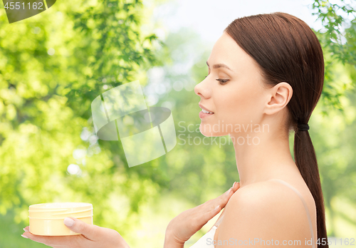Image of beautiful woman with moisturizing cream