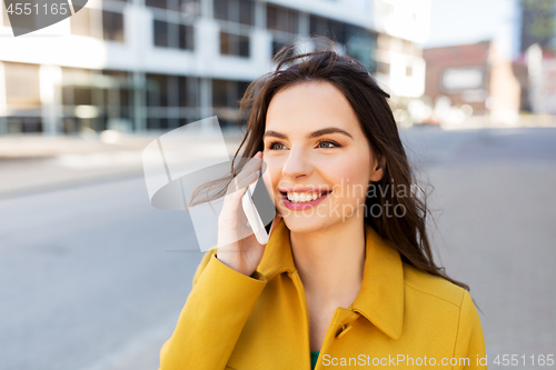 Image of smiling young woman or girl calling on smartphone