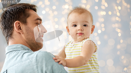 Image of father with little baby daughter at home