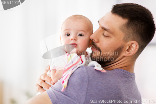 Image of father with little baby girl at home