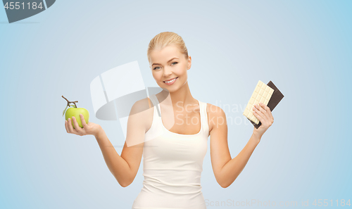 Image of woman choosing between green apple chocolate