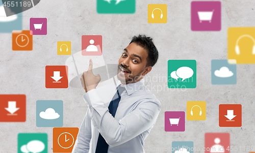 Image of indian businessman pointing finger at app icons