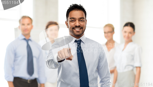 Image of businessman pointing to you over business team