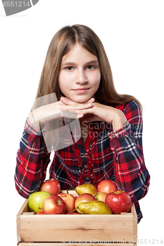 Image of Teen girl with apples and pears in a box