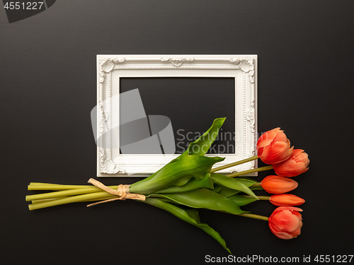 Image of white frame on black background with tulip flowers