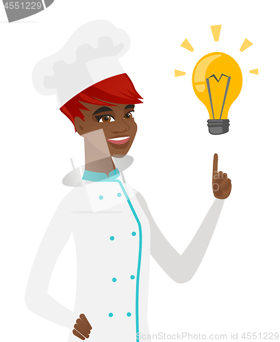 Image of Young african-american chef pointing at lightbulb.