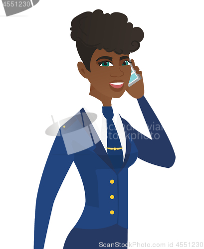 Image of Young african stewardess talking on a mobile phone