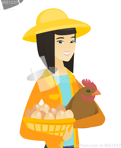 Image of Asian farmer holding chicken and basket of eggs.