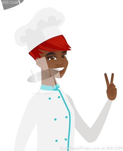 Image of African-american chef cook showing victory gesture