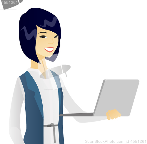 Image of Young asian business woman using a laptop.