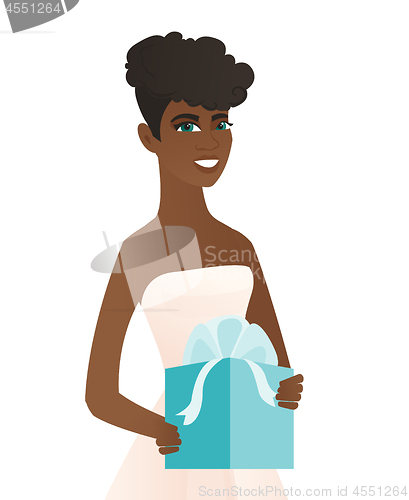 Image of Woman in a white bridal dress holding a gift box.