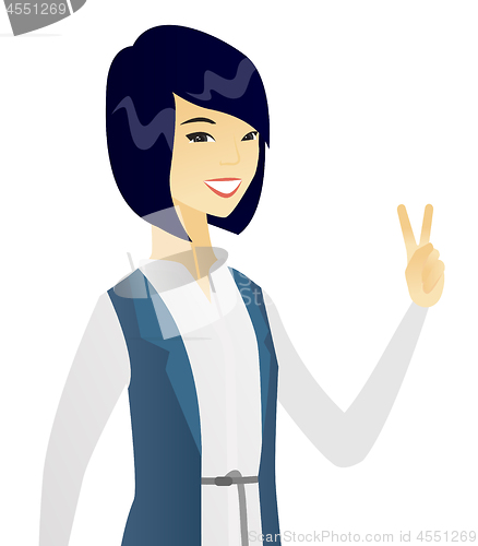 Image of Young asian business woman showing victory gesture