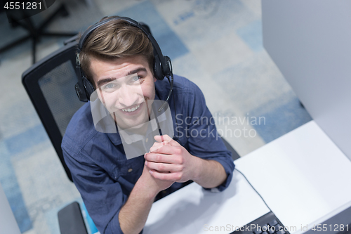 Image of male call centre operator doing his job top view